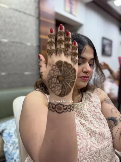 A modern take on the classic peacock mehendi. This design features a stylized peacock on the palm with a simple, elegant floral bracelet.