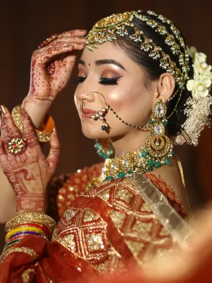 A candid shot of a bride, highlighting the beautiful side profile and the intricate details of her hair and makeup. The shimmer on the eyes catches the light beautifully.