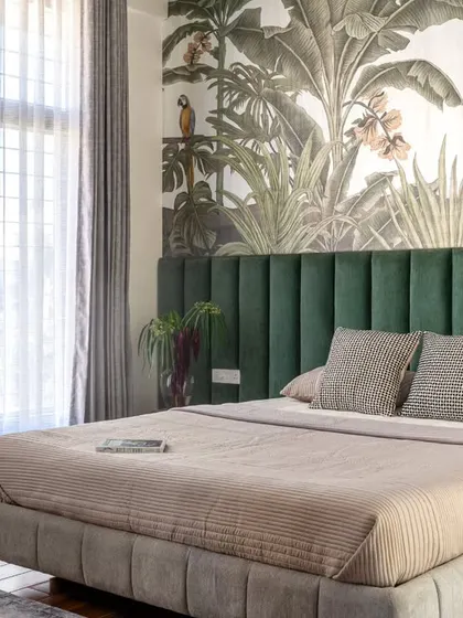 A wider view of the son's room, where the bold tropical wallpaper becomes the centerpiece. We kept the rest of the decor structured and simple to balance the vibrant, animated design of the feature wall.