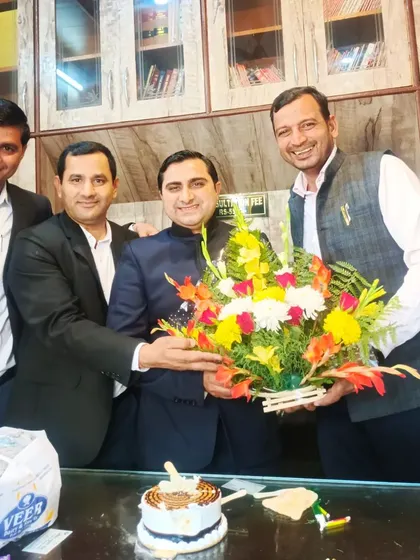 Celebrating a colleague's success with a bouquet and cake. We believe in celebrating each other's achievements as a team.