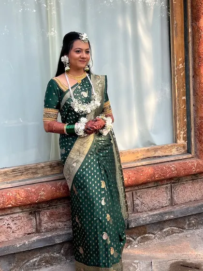 A profile shot of the bride, showing her elegant hairstyle and floral accessories.