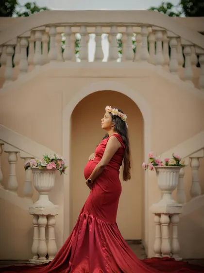A regal and contemplative pose on a grand staircase, creating a timeless and elegant solo portrait.