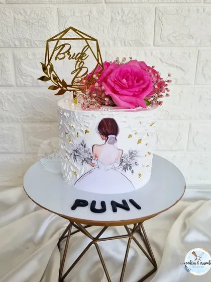 A super pretty off-white cake for a bride-to-be. I used a palette knife to create a textured finish and added a vibrant pink rose for a pop of color.