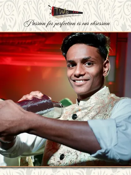 A bartender shakes a cocktail with precision, ensuring it's perfectly chilled and mixed before serving.