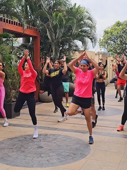 The whole group in a dance pose, showing unity and high spirits. This is what effective team building through fitness looks like.