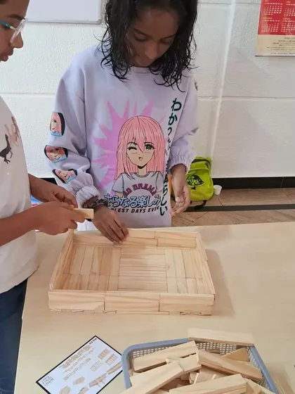 Collaboration is a key skill learned in my workshops. These two builders are working together, combining their ideas to create a sturdy, flat-based structure. This kind of teamwork teaches valuable lessons in communication and shared goals.