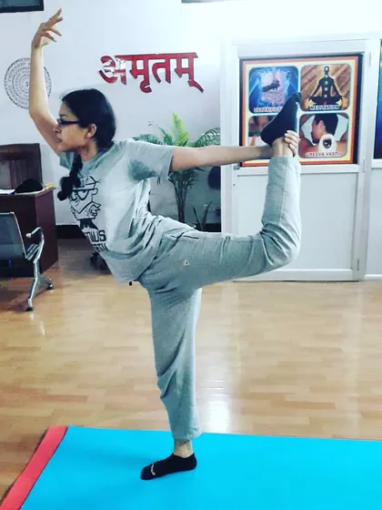 A student practicing Natarajasana (Dancer's Pose), showing balance and grace. This pose is a beautiful expression of the body's potential.