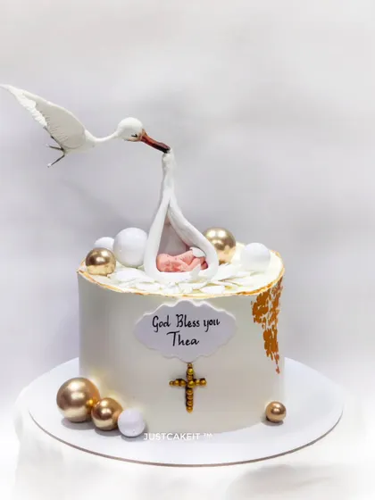 This gravity-defying Baptism cake features a hand-molded stork delivering a baby. It's a delicate and elegant design that showcases my ability to create structurally complex and meaningful edible art.