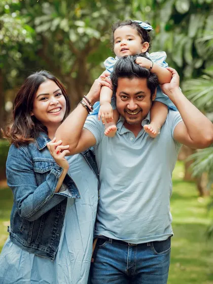A classic family portrait with dad giving his daughter a shoulder ride. These playful moments create the most cherished memories.