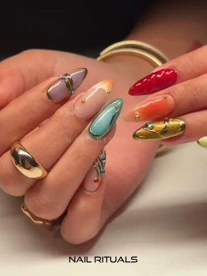 A closer look at the artistry. This shot focuses on the textured details and unique color combinations of this bold and modern manicure.
