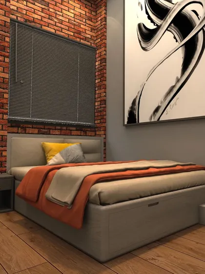 This kid's room combines an industrial edge with playful accents, featuring an exposed brick wall, abstract art, and a comfortable bed with colorful throws.