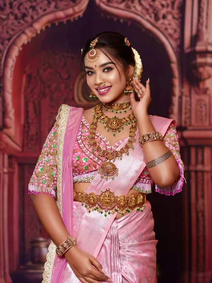 A beautiful bride adorned in a full set of our antique temple jewellery. The layers of necklaces, from the choker to the long haram with its central pendant, create a truly breathtaking Muhurtham look.