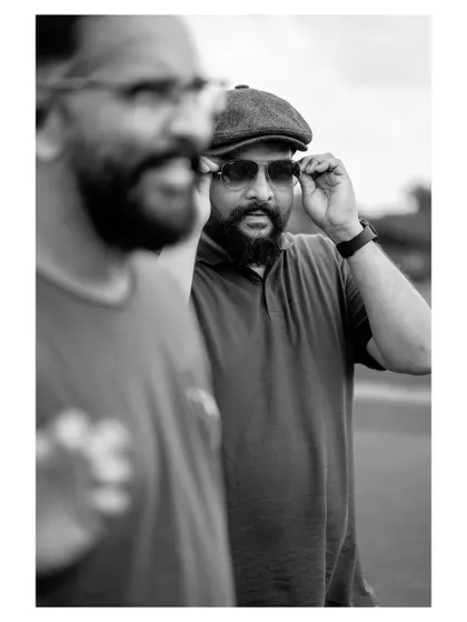 An artistic shot using reflection to create a double portrait. This black and white image has a cinematic quality, telling a story within a single frame.