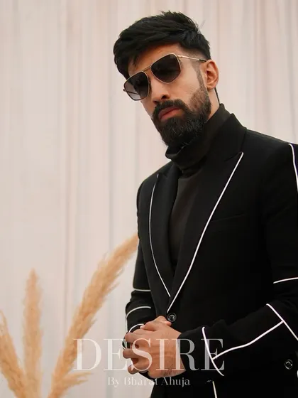 Perfectly tailored to exude confidence and elegance, this black blazer with white piping is a go-to for any occasion that calls for sharp dressing.