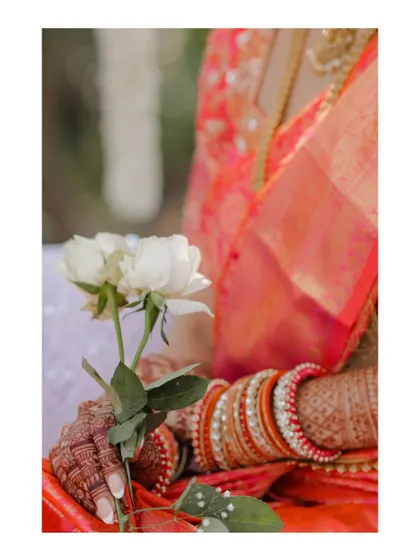 A detailed shot of the bride's hands, showing her mehndi and bangles.