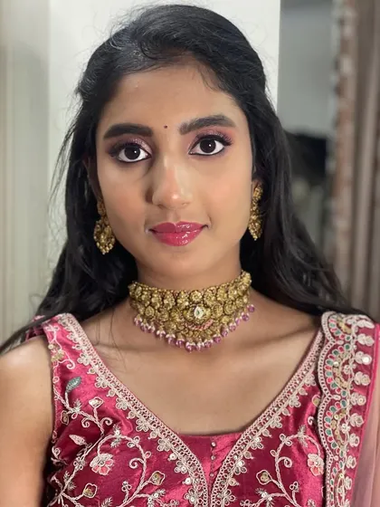 Here is the lovely Neha, ready for her event. I created this party look with shimmery pink eyeshadow, glossy lips, and a half-up hairstyle.