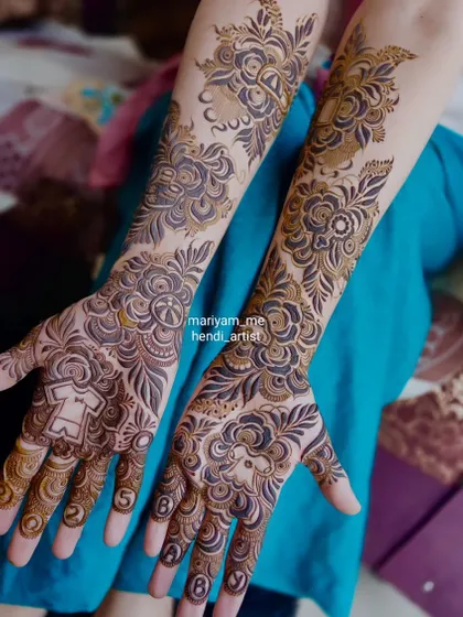 A special baby shower mehendi with cute elements like a baby bottle and footprints.