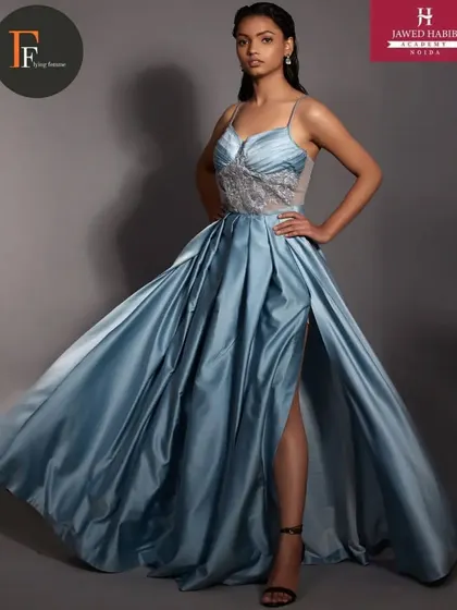 A model in a flowing blue satin gown, styled by our students during a high-fashion portfolio shoot.