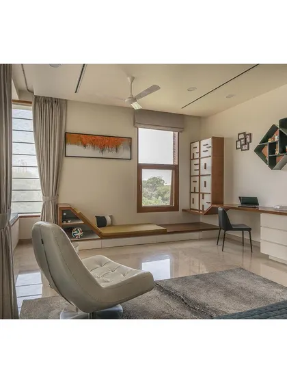 We designed this bedroom to be a multi-functional space. It includes a dedicated study area and a unique, built-in lounge space, demonstrating how we tailor interiors to support our clients' lifestyles.