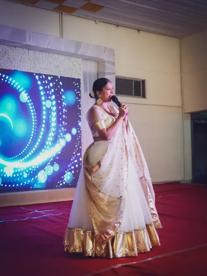 Another angle from the same event, showing my traditional attire and confident stage presence.