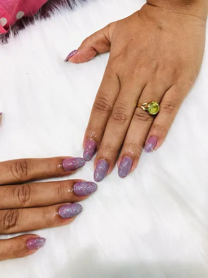 These unicorn nails feature a beautiful iridescent glitter that shifts colors in the light.