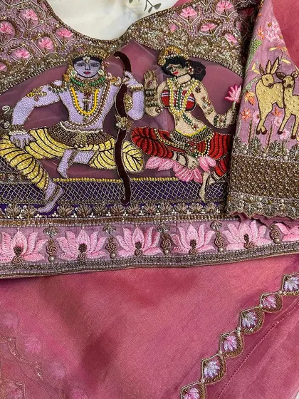 A detailed shot of the Janaki Rama blouse, showing the intricate embroidery of the divine couple.