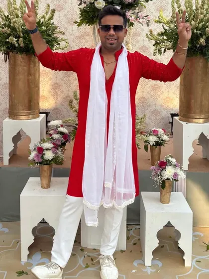 Victory signs! Feeling the positive energy in my bright red traditional wear. Ready to rock the event.