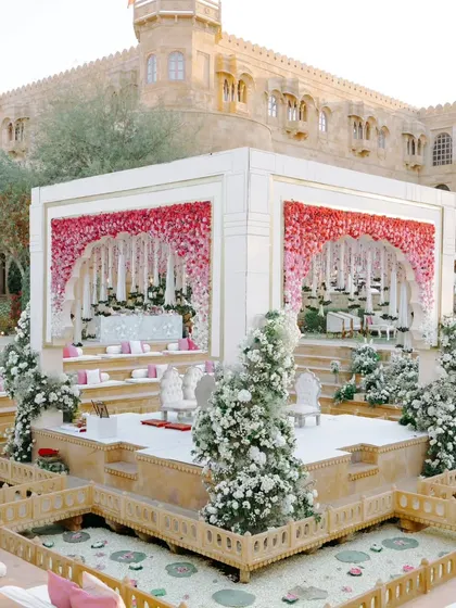 A fairytale mandap at Suryagarh, adorned with a gradient of pink and white florals. The design creates a beautiful contrast with the heritage architecture, blending romance and royalty.