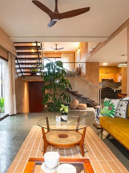 This living room from the Earth Villa project is a celebration of natural textures and mid-century design. I used lime plaster on the walls to create a warm, tactile backdrop for the artisan-crafted furniture. The vibrant, hand-painted artwork and carefully chosen decor infuse the space with personality and a sense of wellness.
