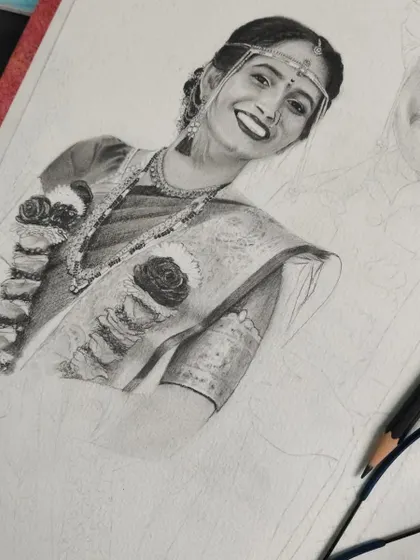 Another angle of the wedding portrait in progress. I am focusing on the intricate details of the bride's attire, using fine pencils to capture every element.