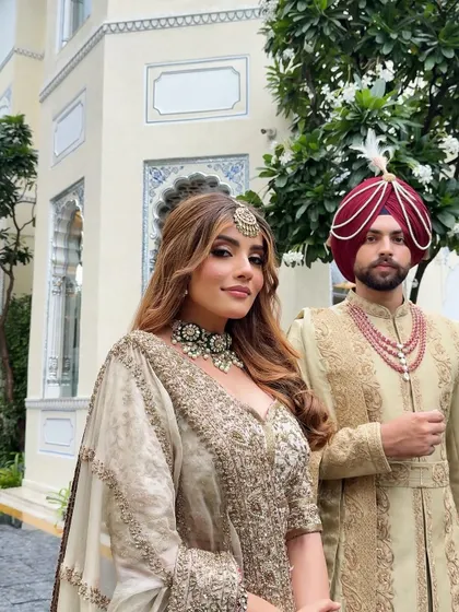 A portrait of modern royalty. The couple's coordinated ivory ensembles are a testament to understated luxury, perfect for a sophisticated daytime wedding ceremony.