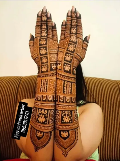 A full-arm design with repeating blocks of lotus and swastika motifs, creating a beautiful and symbolic pattern.