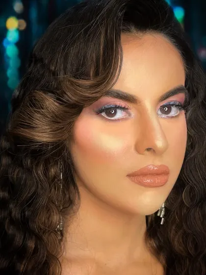 A beautiful evening glam look with a pop of blue and pink. The close-up shot shows the importance of detailing and blending for a seamless finish.