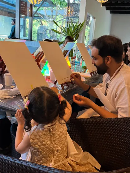 A father and daughter duo enjoying a creative moment at a birthday paint party. Our events are for all ages, making them a great way for families and friends to connect and celebrate together.