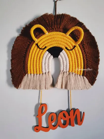 This macrame lion wall hanging with the name 'Leon' is a perfect fit for a kid's room or nursery. It's an eco-friendly and sustainable gifting option.