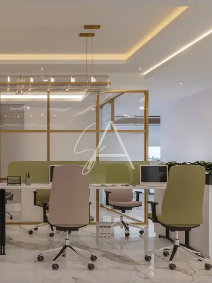 Another view of the shared workspace, showing how the glass partitions and open layout encourage a collaborative yet organized environment.