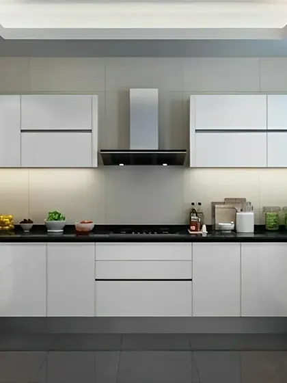This high-contrast kitchen uses glossy black and white cabinets for a sleek and ultra-modern look. The minimalist hardware and integrated appliances maintain the clean lines, creating a sophisticated and polished cooking environment.