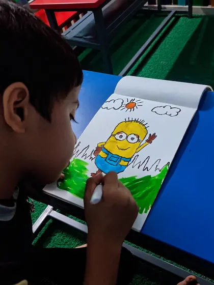 Another shot of the student engrossed in his Minion artwork, using markers to fill in the colors.