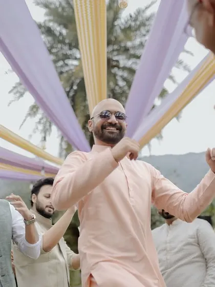 The groom dances with his friends, enjoying the high-energy celebration at his wedding reception.