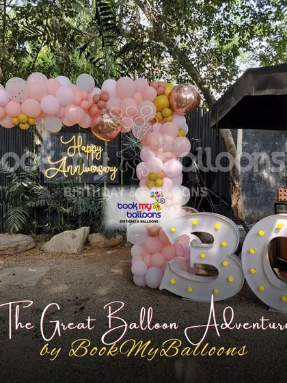 We celebrated a 30th anniversary with this beautiful outdoor setup. The decor featured a "Happy Anniversary" neon sign, light up marquee numbers, and a lovely pink and gold balloon arrangement, creating a romantic and festive ambiance.