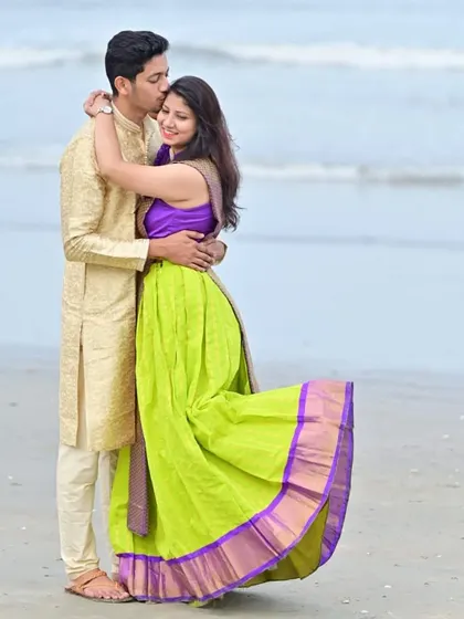 A sweet and romantic moment from the beach photoshoot. The coordinated colors of their outfits look beautiful against the sea and sand.