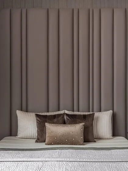 For the son's room, we used rich brown tones to create a warm and inviting atmosphere. The textured, vertically paneled headboard adds depth, while embellished silk pillows provide a touch of luxury.