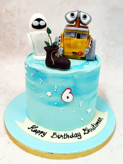 We celebrate a futuristic friendship with this heartwarming Wall-E and Eve cake. The detailed, handcrafted figures of the beloved robots are placed on a celestial blue cake, complete with the iconic boot plant, capturing the magic of the classic Pixar film.