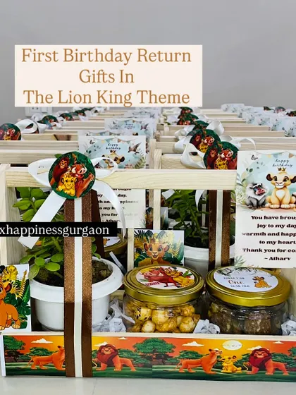 A 'Lion King' themed return gift that includes a healthy plant alongside jars of treats. The personalized card and themed basket complete this unique, green party favor.
