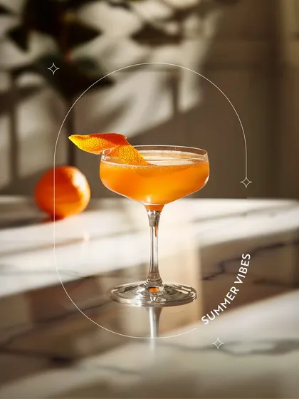 A refreshing orange mocktail in a coupe glass, capturing the essence of summer vibes. This shows that even without alcohol, you can enjoy a sophisticated and flavourful drink.