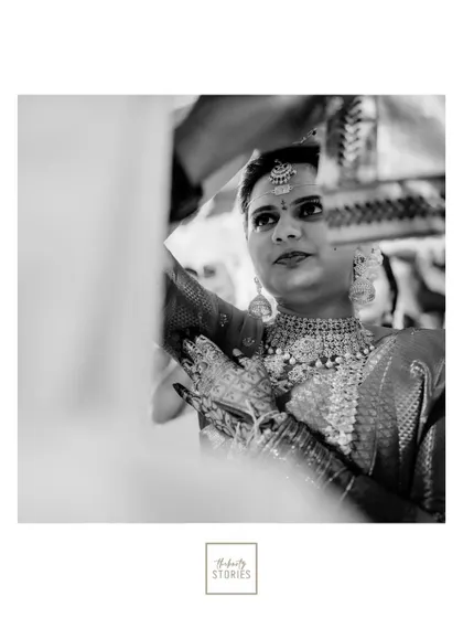 A striking black and white portrait of the bride, her gaze focused and intense, highlighting her timeless beauty.