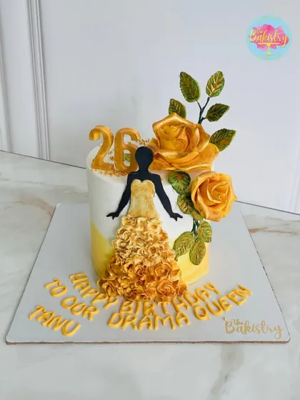 A stunning cake for a "drama queen," featuring a silhouette in a flowing golden gown and beautiful yellow roses.