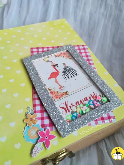 A detailed shot of the personalized shaker frame, filled with colorful sequins that move around.