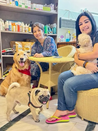 Look at these happy faces. This picture captures the essence of our community, with pet parents and their furry children, including a Golden Retriever, a Pug, and a Shih Tzu, all enjoying their time together. This is the family I always dreamed of building.