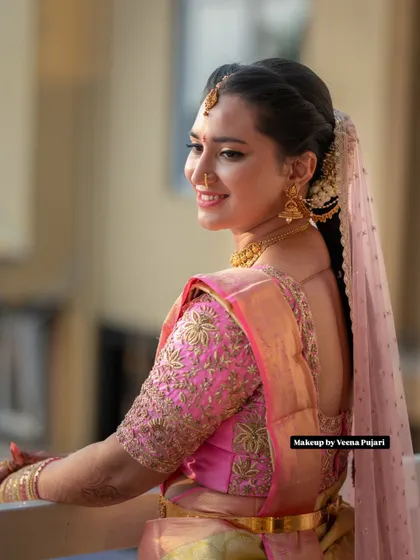 A candid moment of happiness. This bride's soft glam makeup and elegant hairstyle are perfect for a day ceremony, looking fresh and radiant in the natural light.
